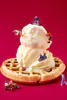 A staged photographic print with mini figures skiiing on ice cream and waffles by New Zealand artist Adam Popovic, located at The Little Gallery Whangamata